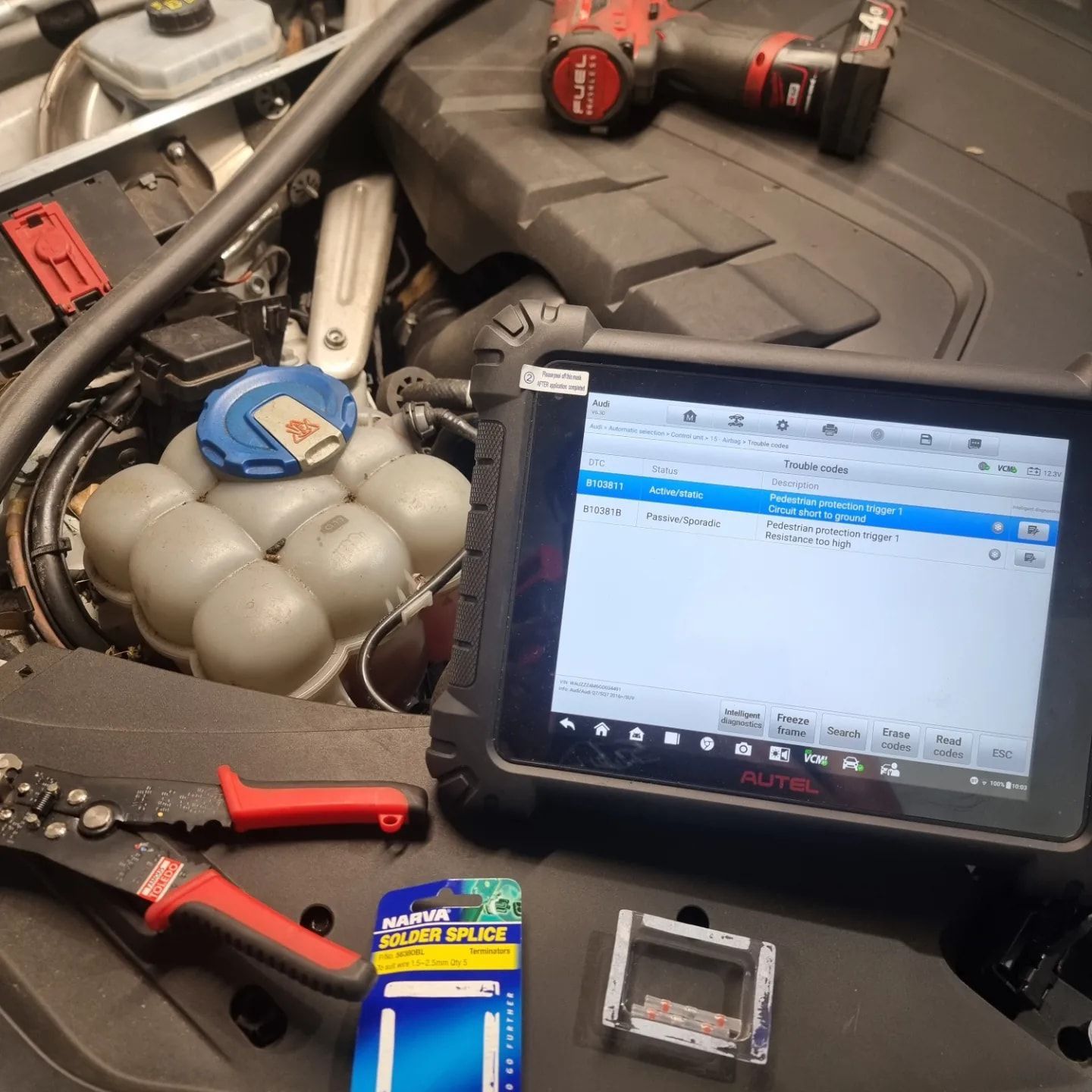 A car engine bay with diagnostic tablet, tools, and parts. Repair work in progress — MC Automotive Service & Repairs in Maitland, NSW