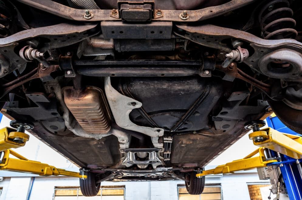 Underside View Of A Car On A Lift, Revealing Suspension — MC Automotive Service & Repairs in Maitland, NSW
