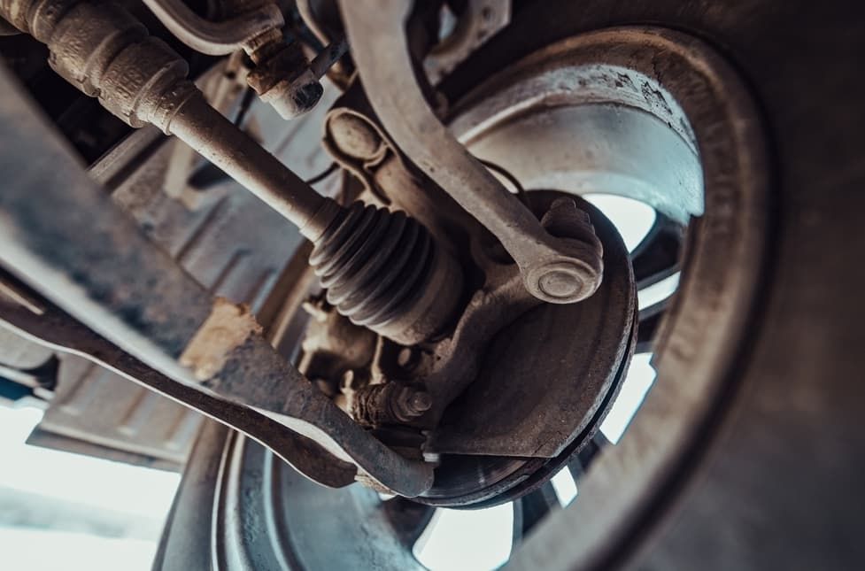 Close-up View Of A Vehicle's Undercarriage, Showing Suspension Components — MC Automotive Service & Repairs in Maitland, NSW