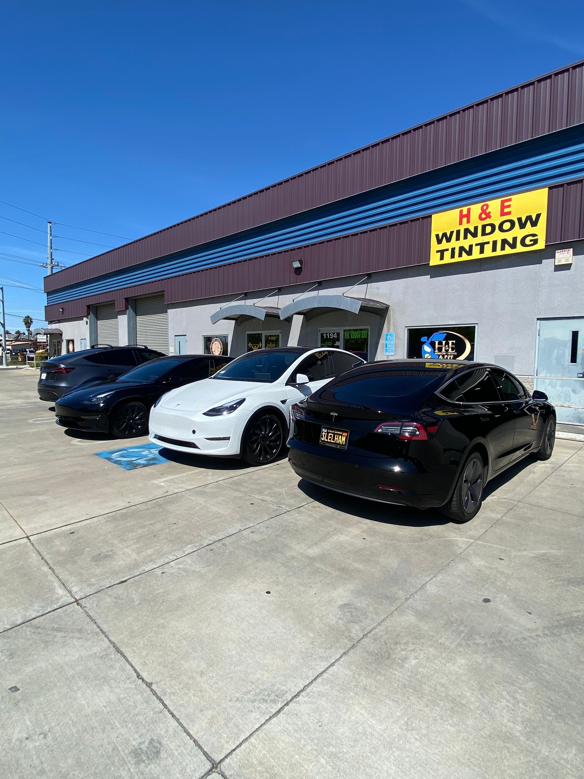 Four cars parked in front of a building with