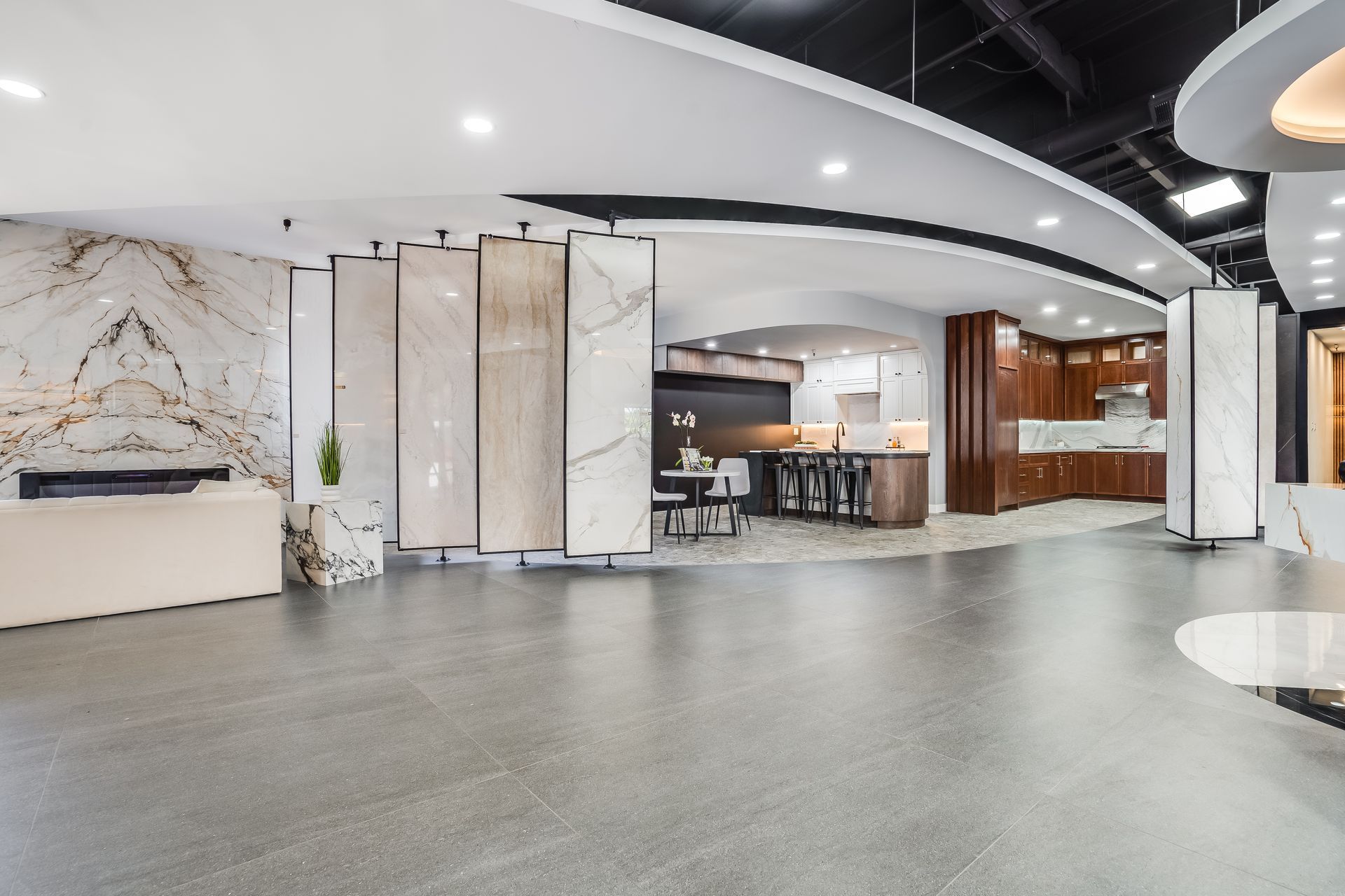 Showroom interior with tile and kitchen displays, neutral tones.