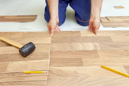 Kent Handyman installing laminate flooring