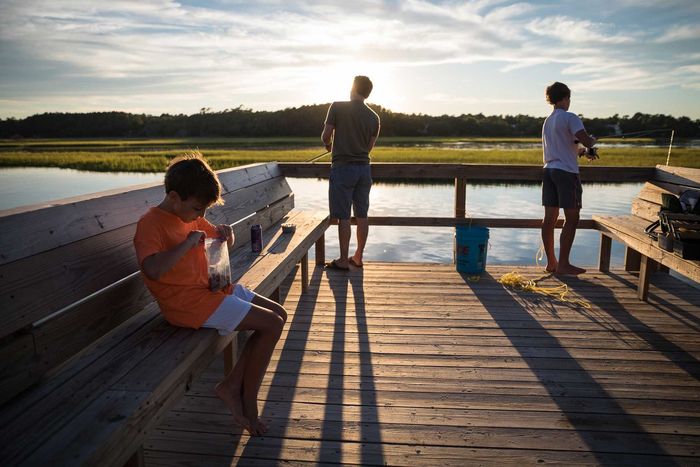 A group of boys fishing the waters of the Lowcountry from a dock on Pawleys Island, SC. Photo provided by Mac Stone.