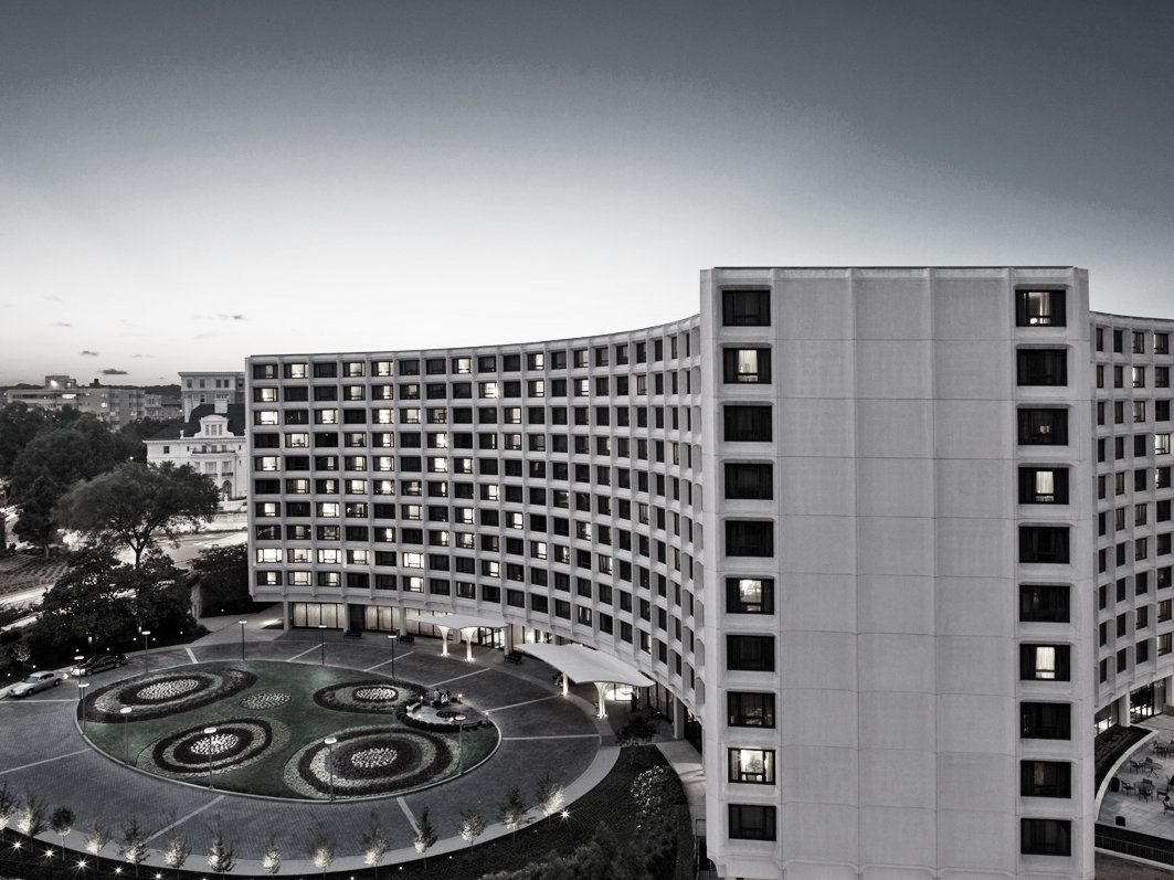 A black and white photo of a large building with a lot of windows