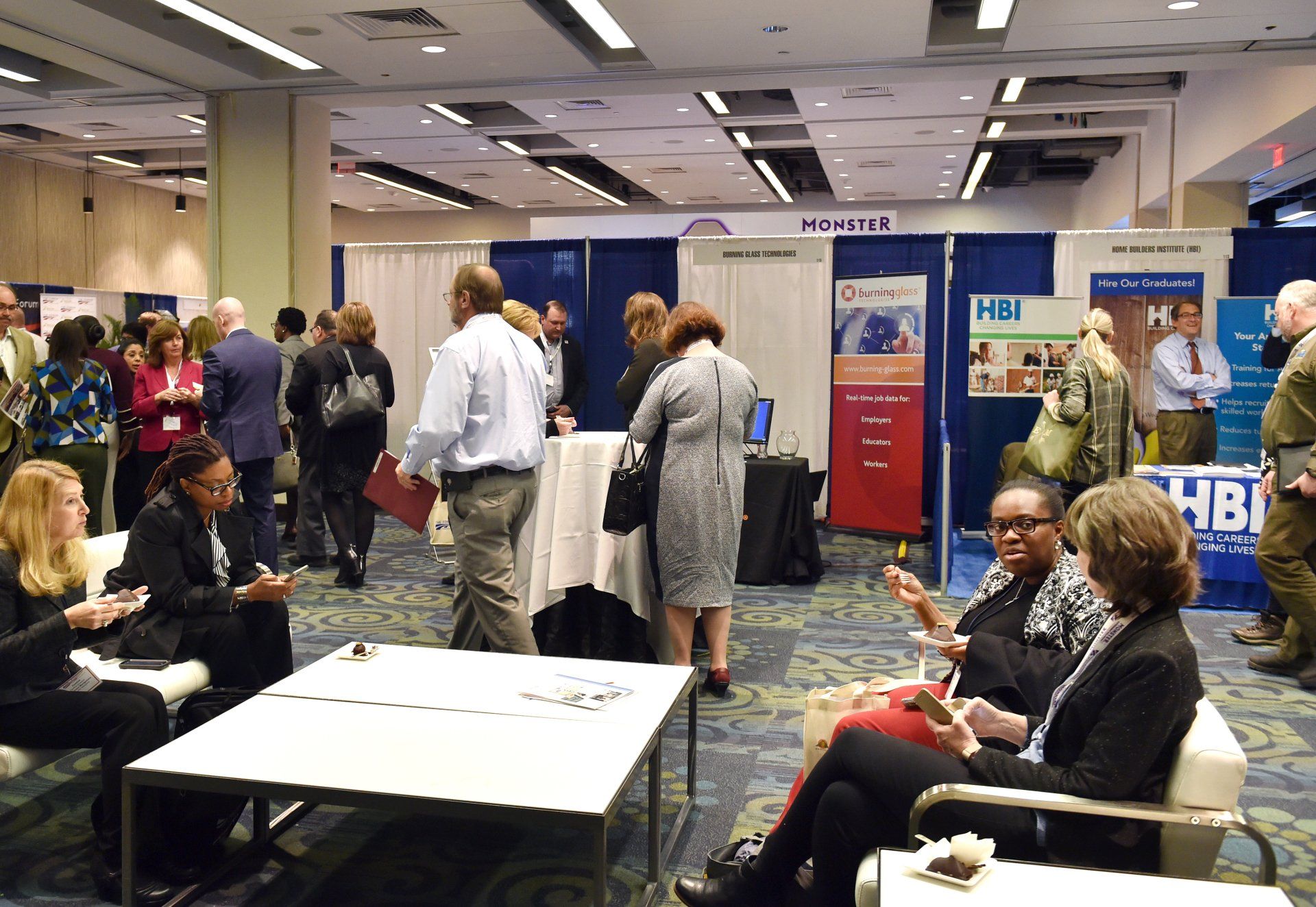 A group of people are sitting in a room at a convention.