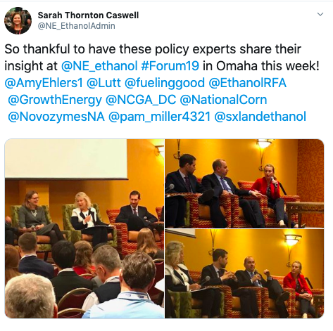 A group of people are sitting in chairs at a conference.