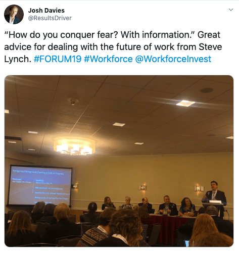 A group of people are sitting in a room watching a presentation.