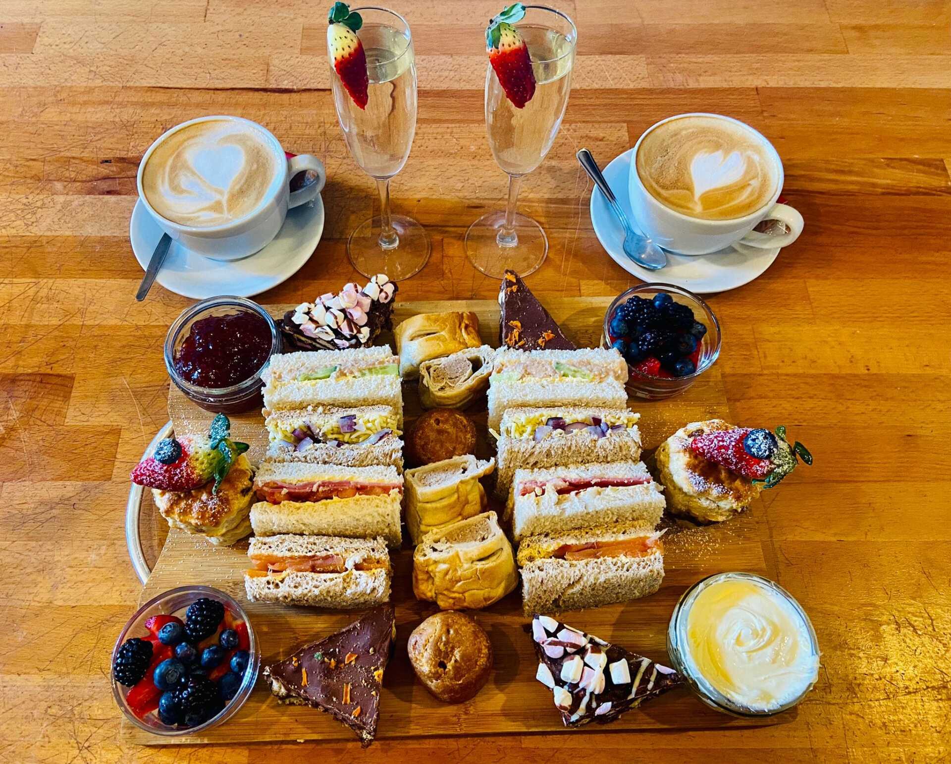 Afternoon tea. Sandwiches, cakes, tea and prosecco 