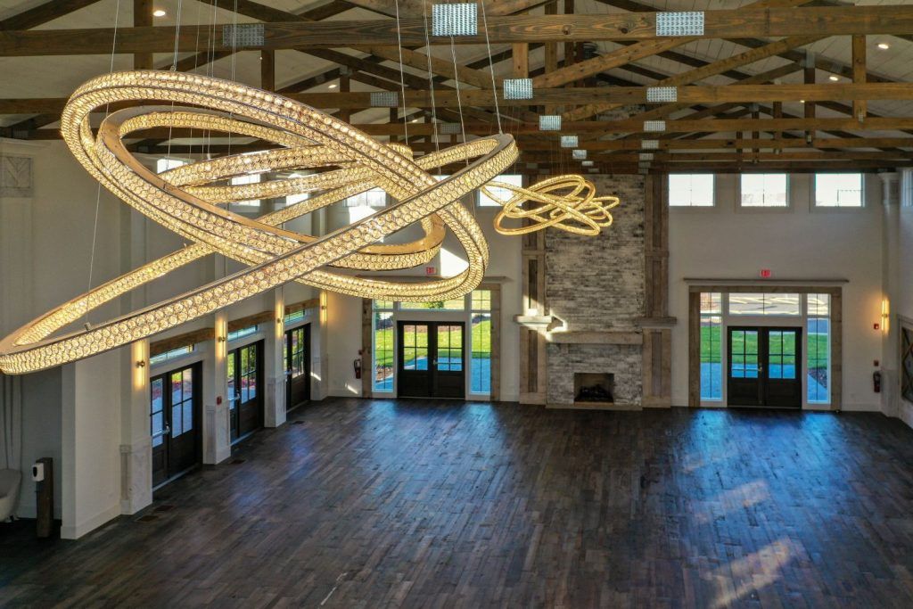 A large empty room with a lot of lights hanging from the ceiling.