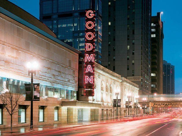 A building with a neon sign that says goodman on it
