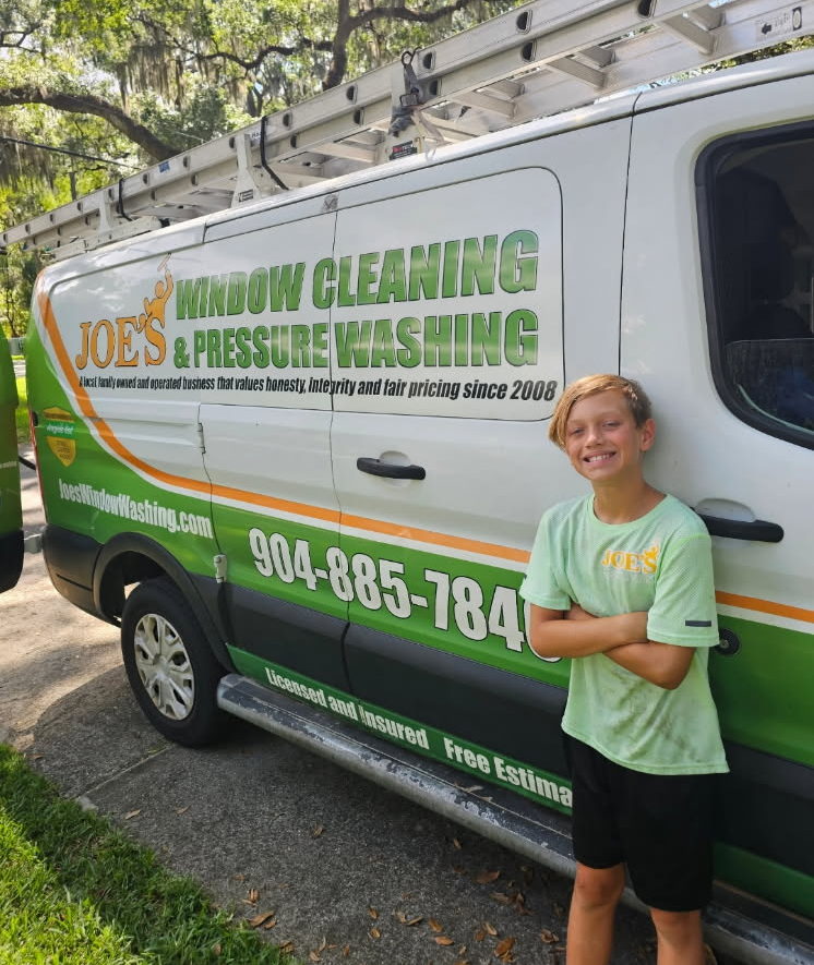 A man and a boy are standing next to each other at a table.