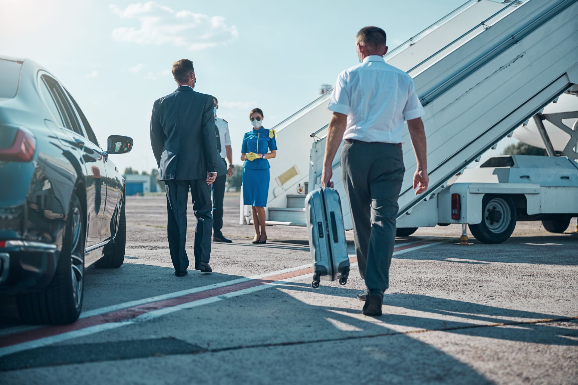 A group of people are walking towards an airplane.