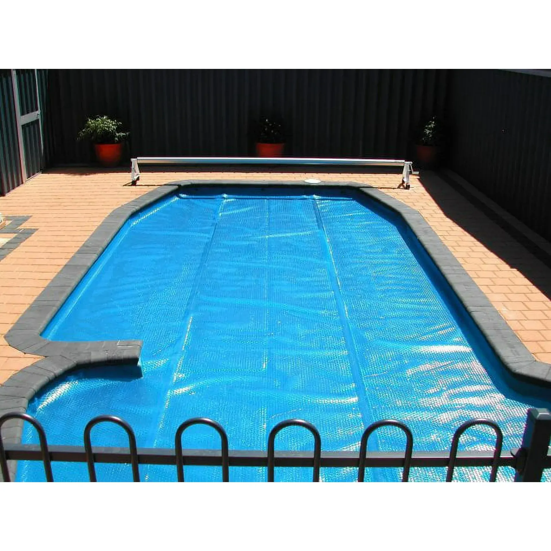 A swimming pool with a blue cover on it