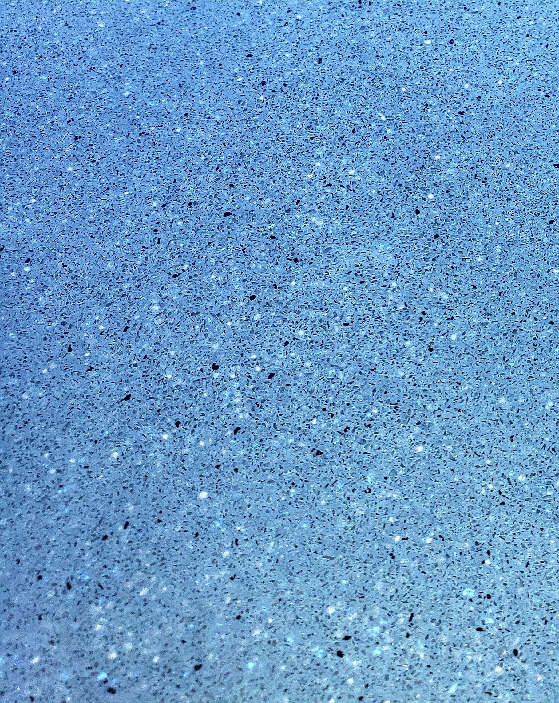 A close up of a blue and white carpet texture.