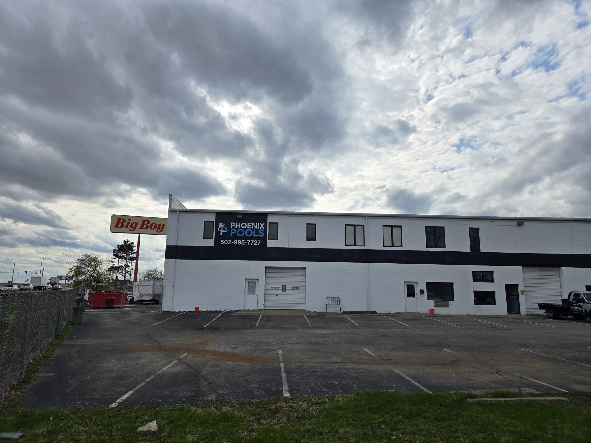 A large white building with a billy roger sign in front of it