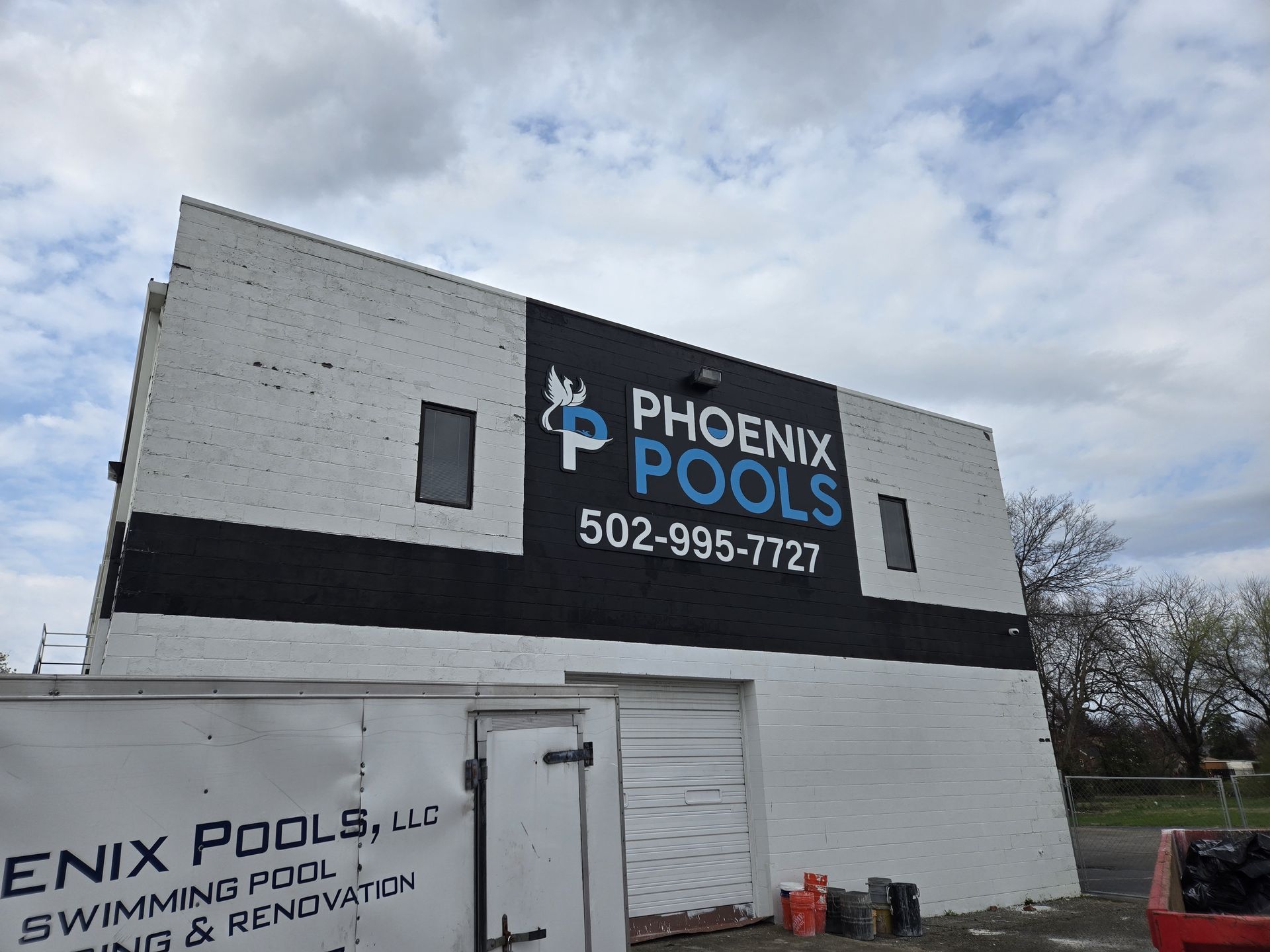 A building with a sign on the side that says phoenix pools