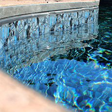 A swimming pool with a reflection of trees in the water