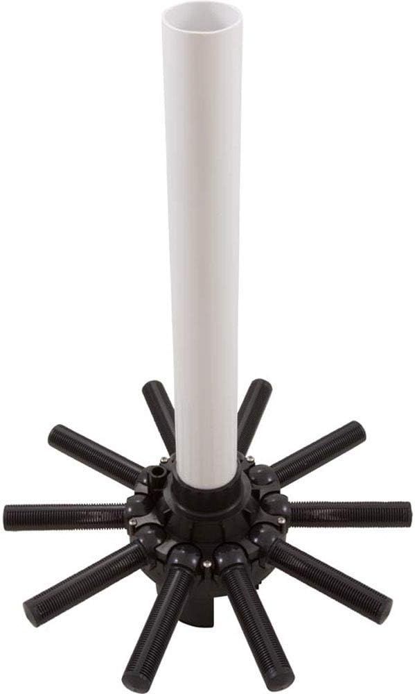 A white pipe is sitting on top of a black circular object.