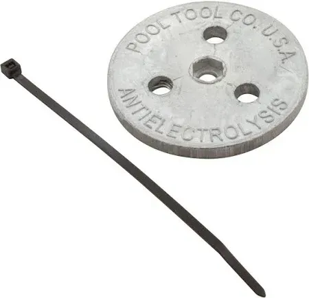 A black tie is attached to a metal disc that says antielectrolysis on it.