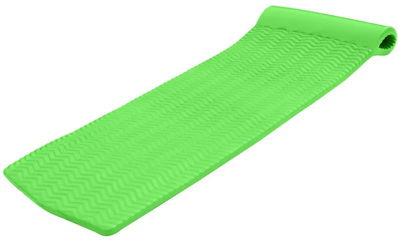 A green foam mattress is sitting on a white surface.