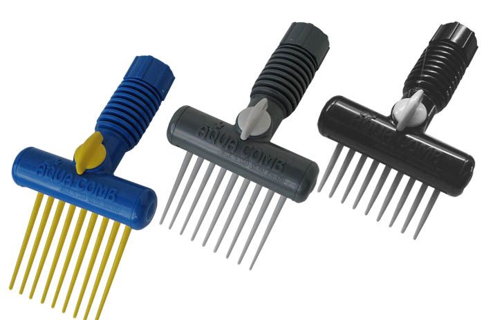 Three combs are lined up in a row and one has a yellow handle