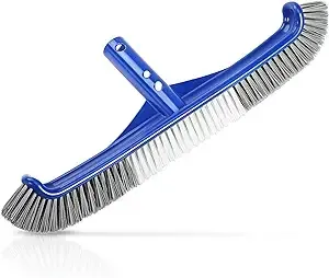 A blue brush with gray bristles is sitting on a white surface.