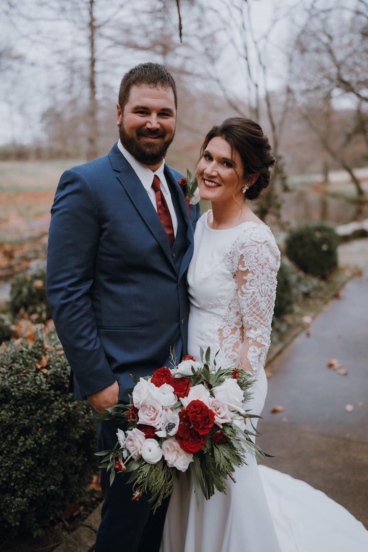 A bride and groom are posing for a picture on their wedding day.