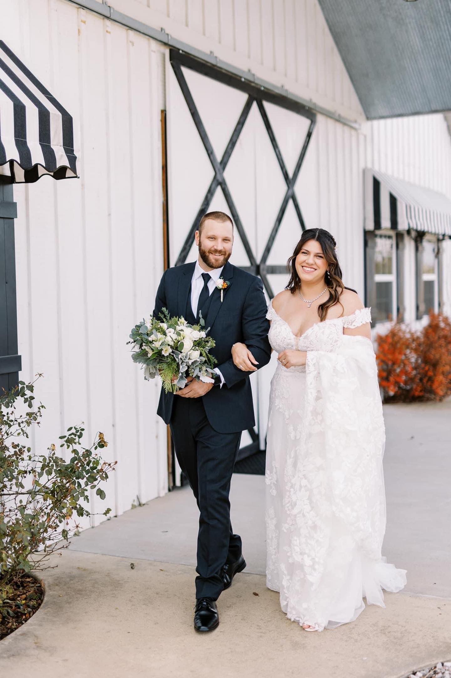 A bride and groom are walking down the aisle at their wedding.