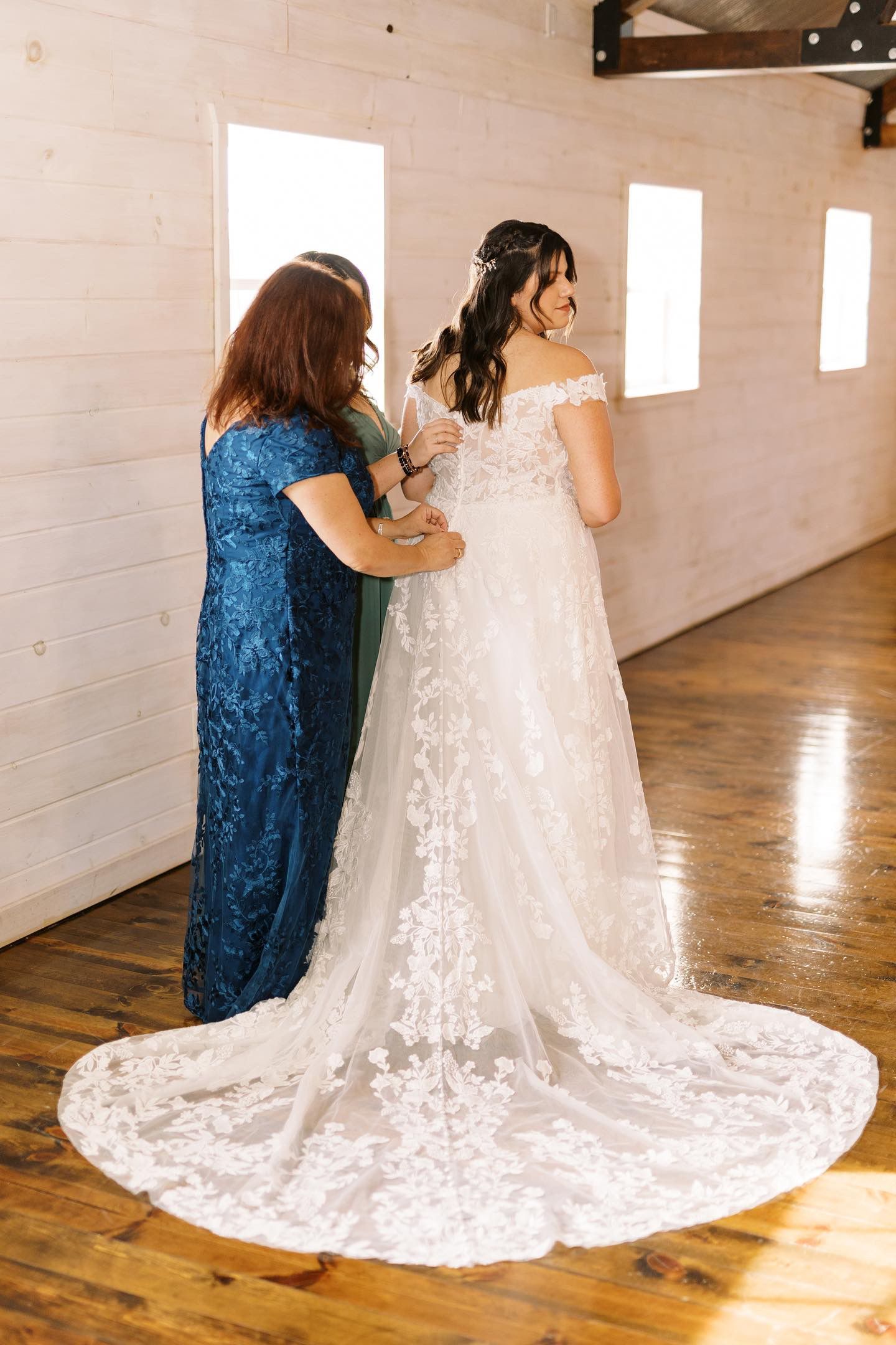 A bride is getting ready for her wedding with her mother.