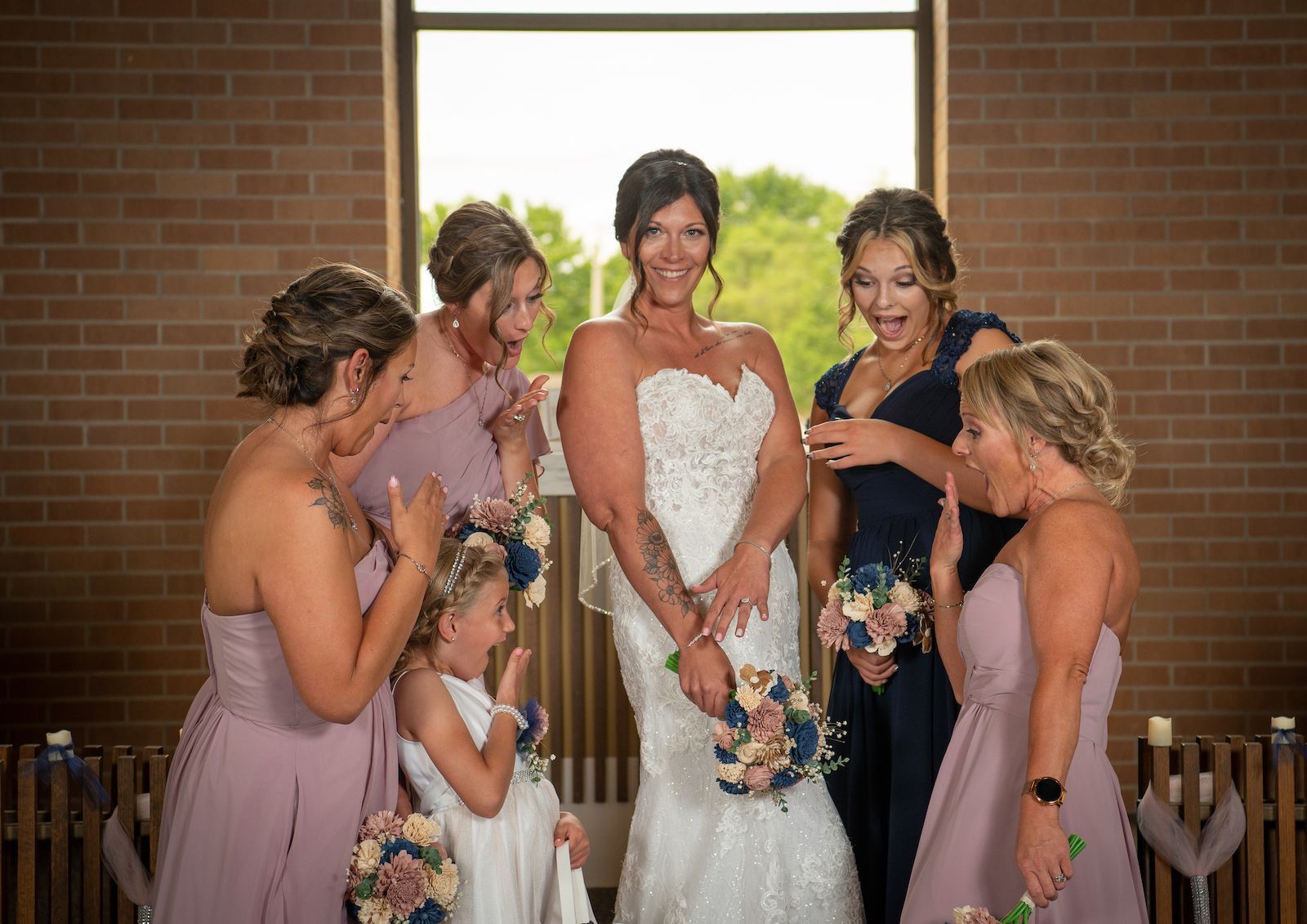 A bride and her bridesmaids are posing for a picture in a church.