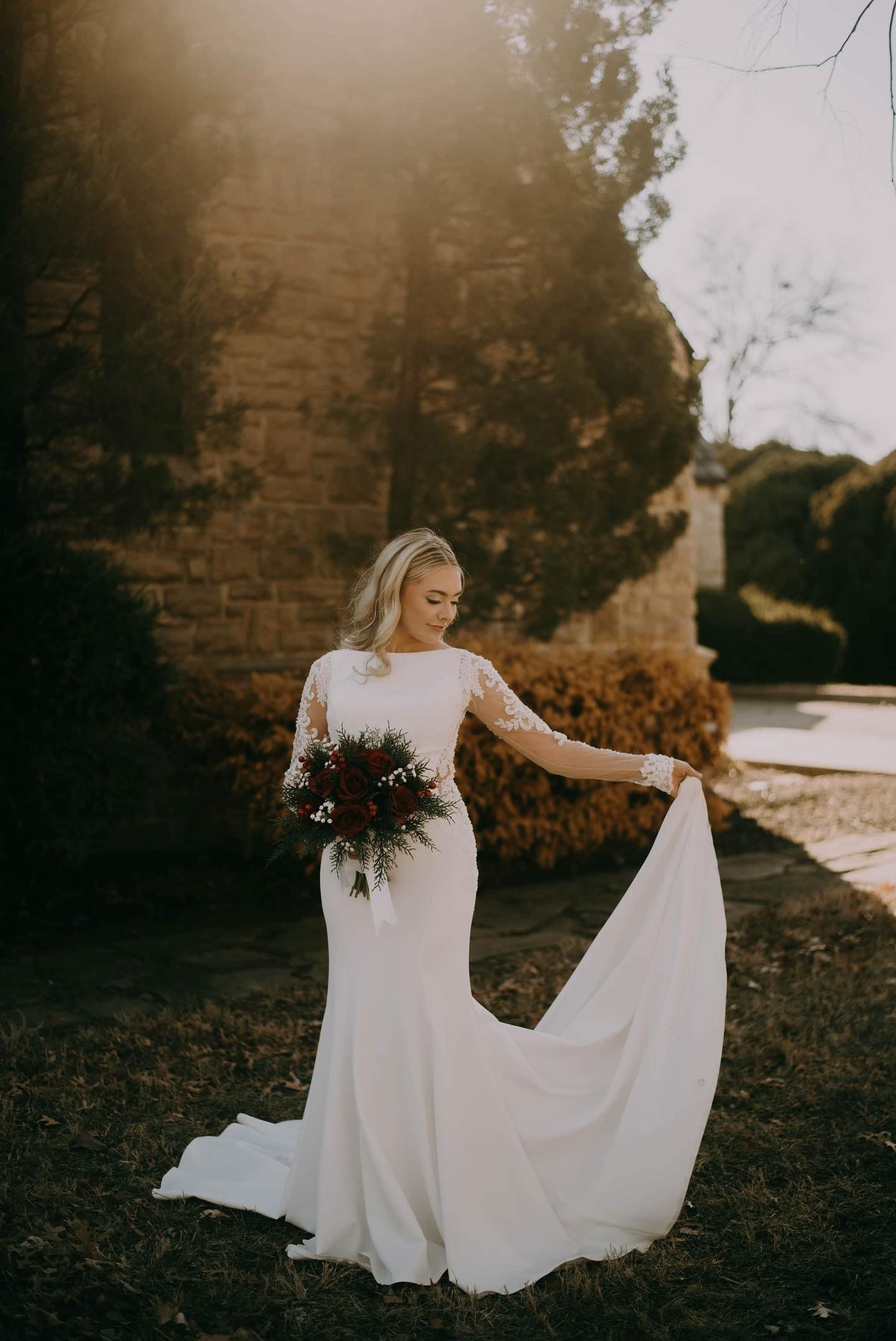 The bride is wearing a white wedding dress and holding a bouquet of flowers.