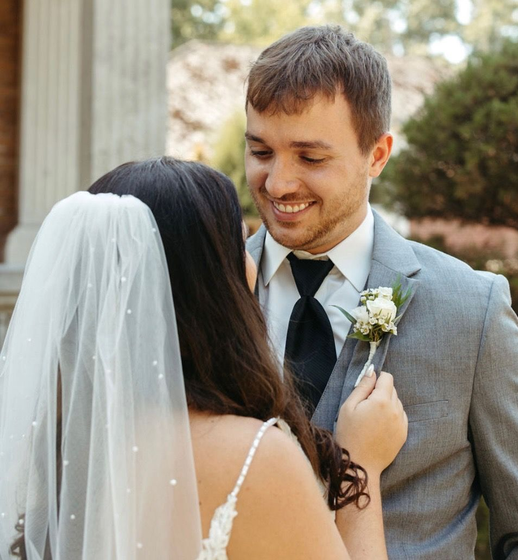 Two men in suits and ties are standing next to a pool table.