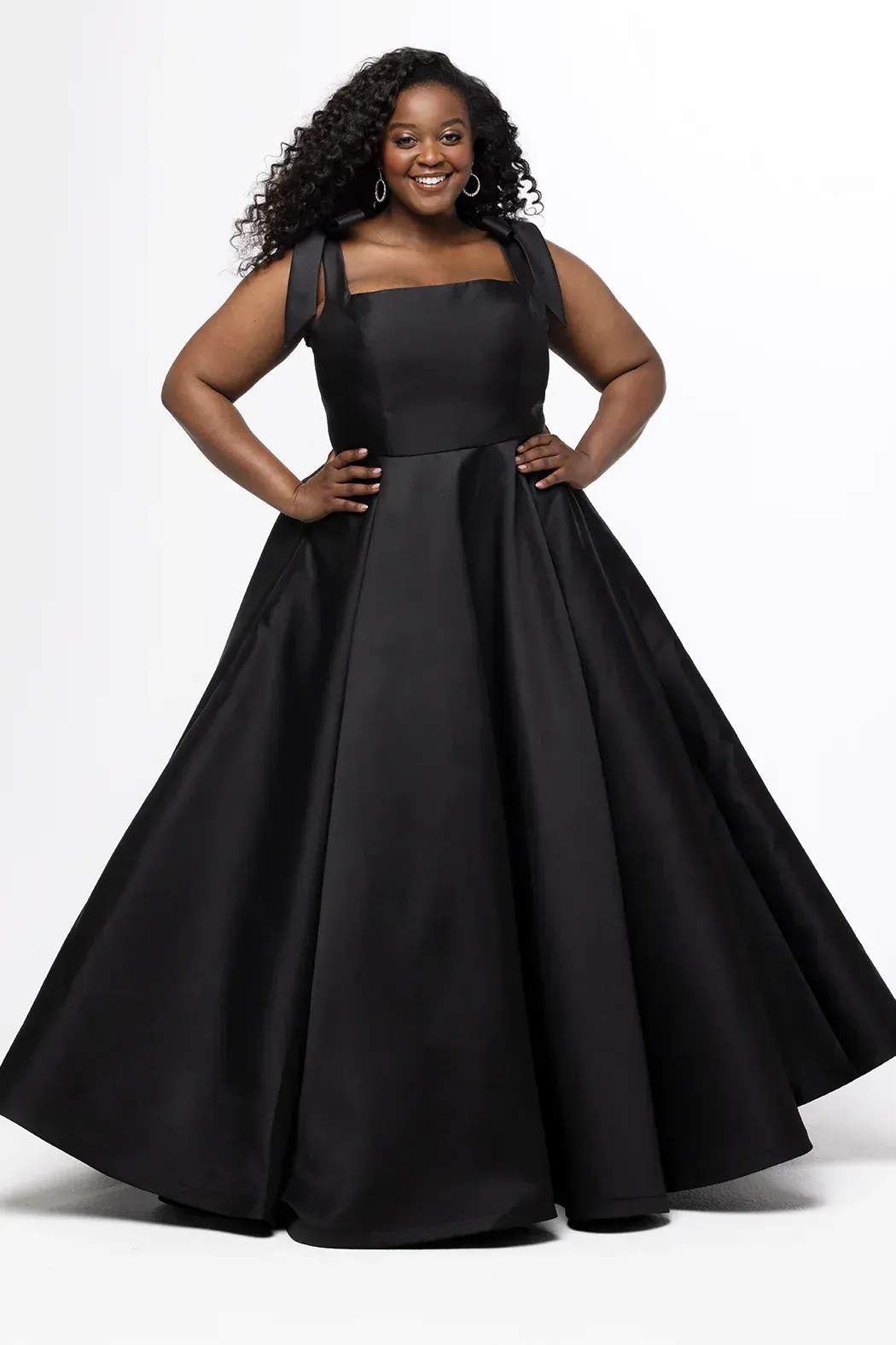 A woman is wearing a green dress with a high slit and a corset top.