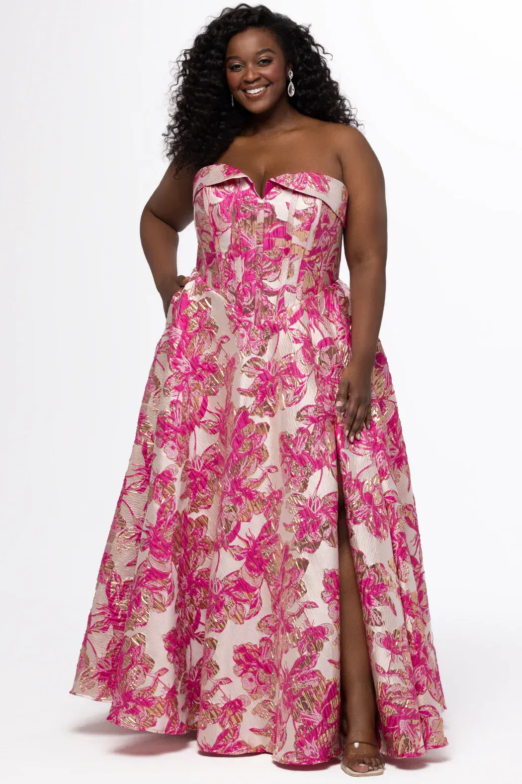 A woman is wearing a pink off the shoulder dress.