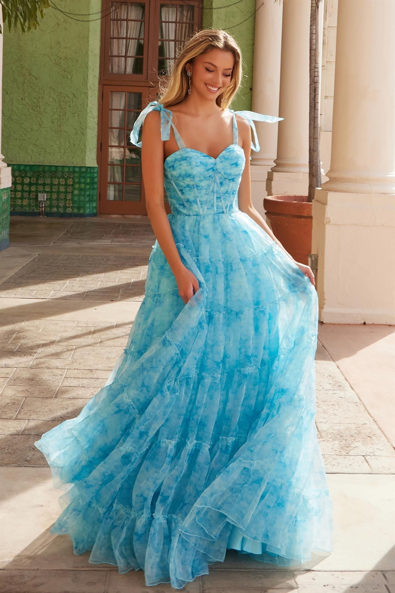 Two women are standing next to each other wearing dresses.