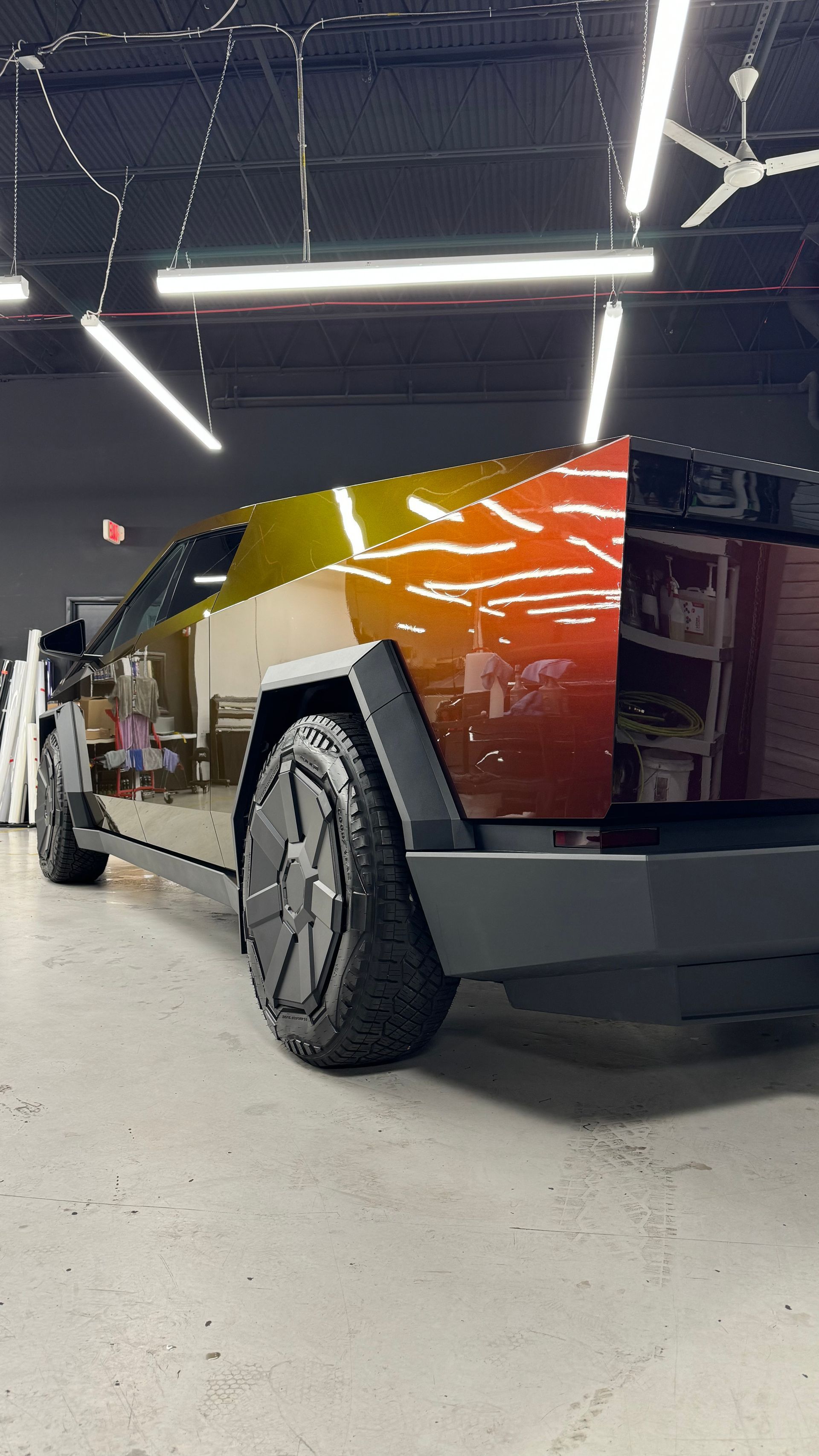 A tesla cybertruck is parked in a garage.