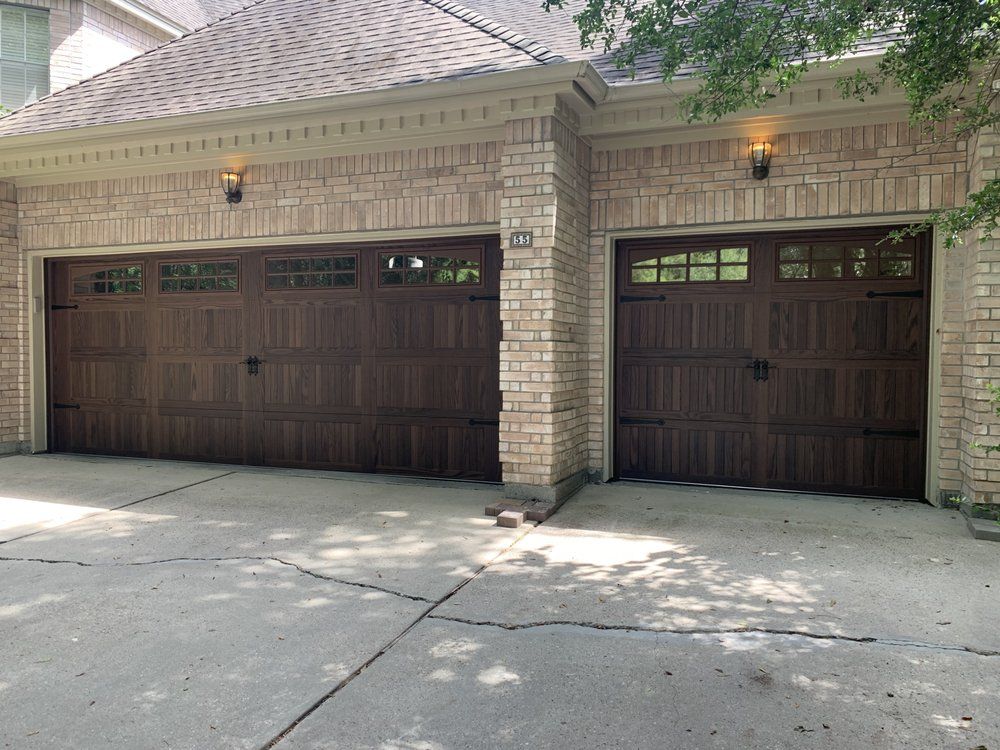A brick building with two brown garage doors