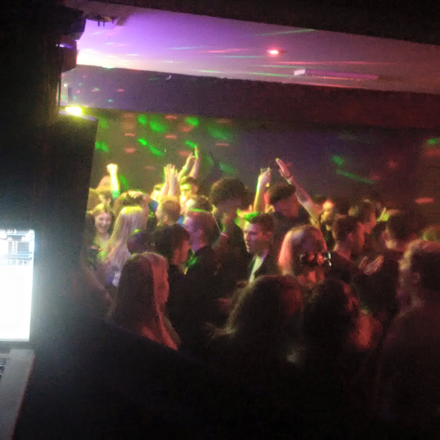 young adults dancing in hotel night club setting.