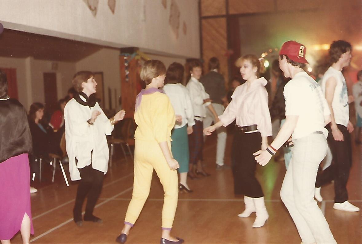 Teenagers  dancing in a typical village hall birthday disco.