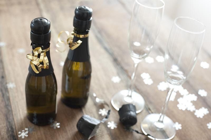 bottles of champagne and glasses with confetti.