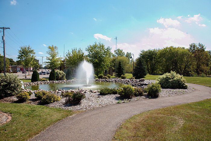 there is a fountain in the middle of the park .