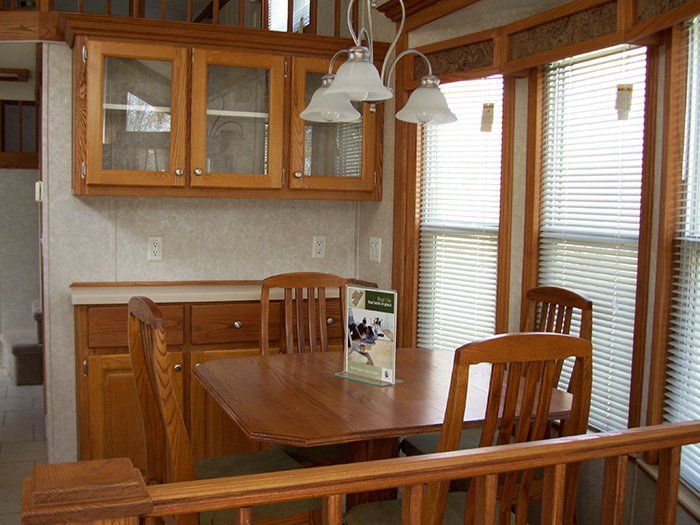 a dining room with a wooden table and chairs