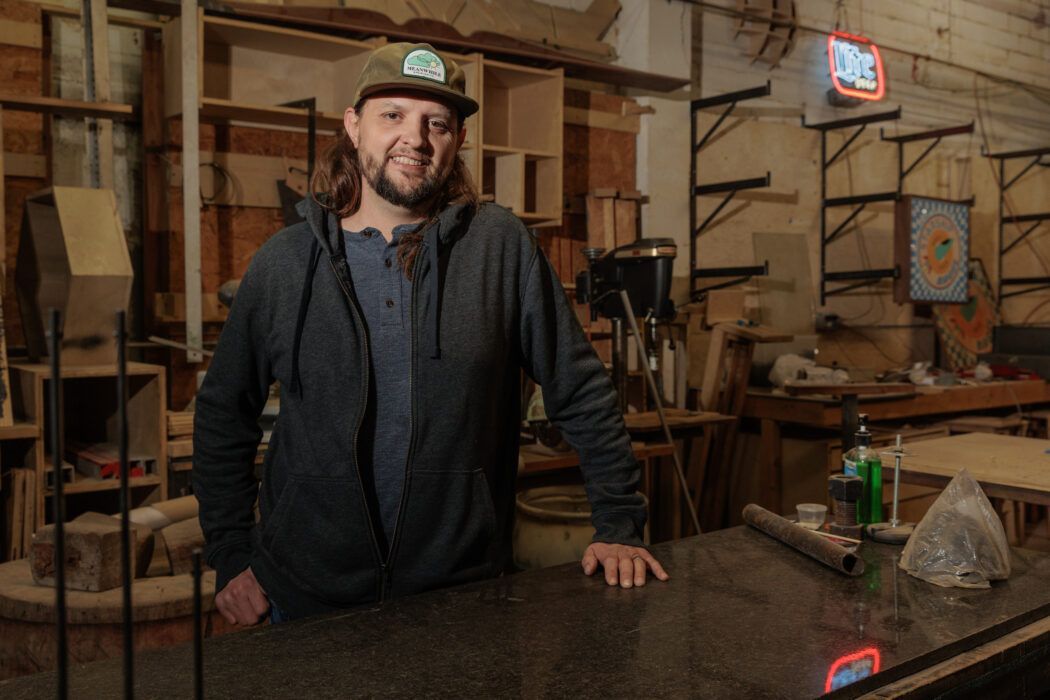 A man is standing in front of a counter in a room.