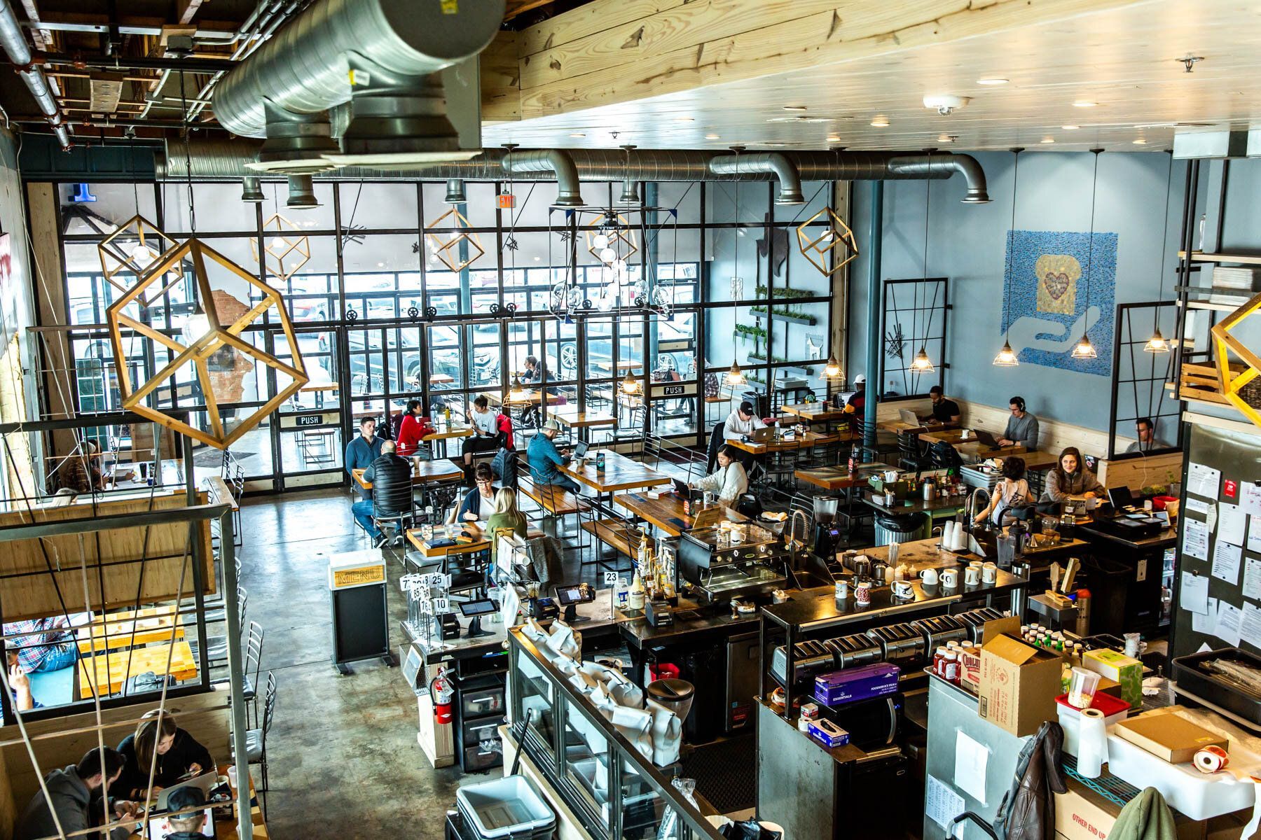 An aerial view of a restaurant filled with people sitting at tables.