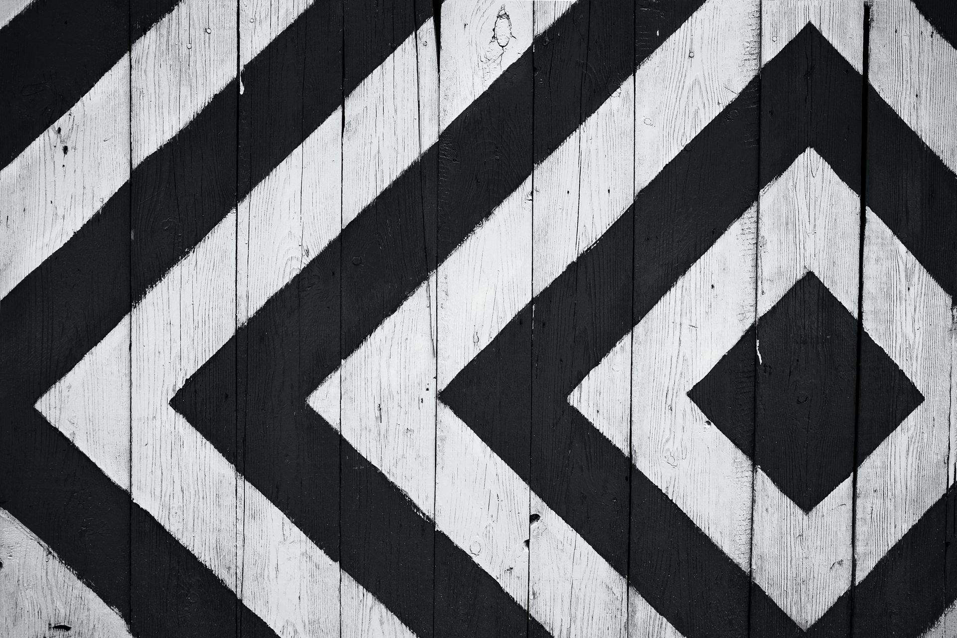 A black and white striped pattern on a wooden surface.
