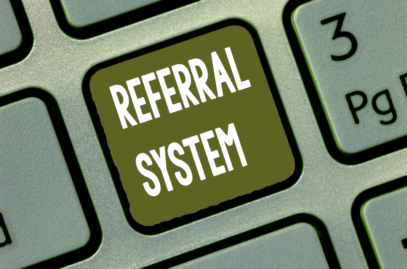 Keyboard key labeled “REFERRAL SYSTEM” next to a key marked “3 Pg”