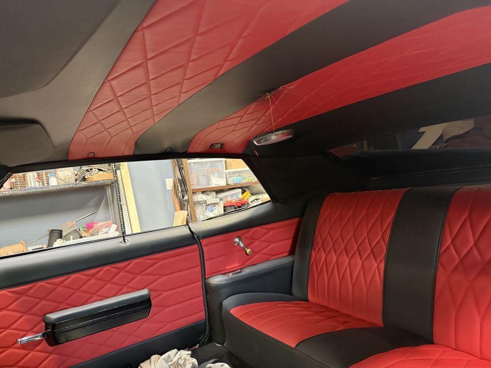 Red and black custom car interior with quilted upholstery.