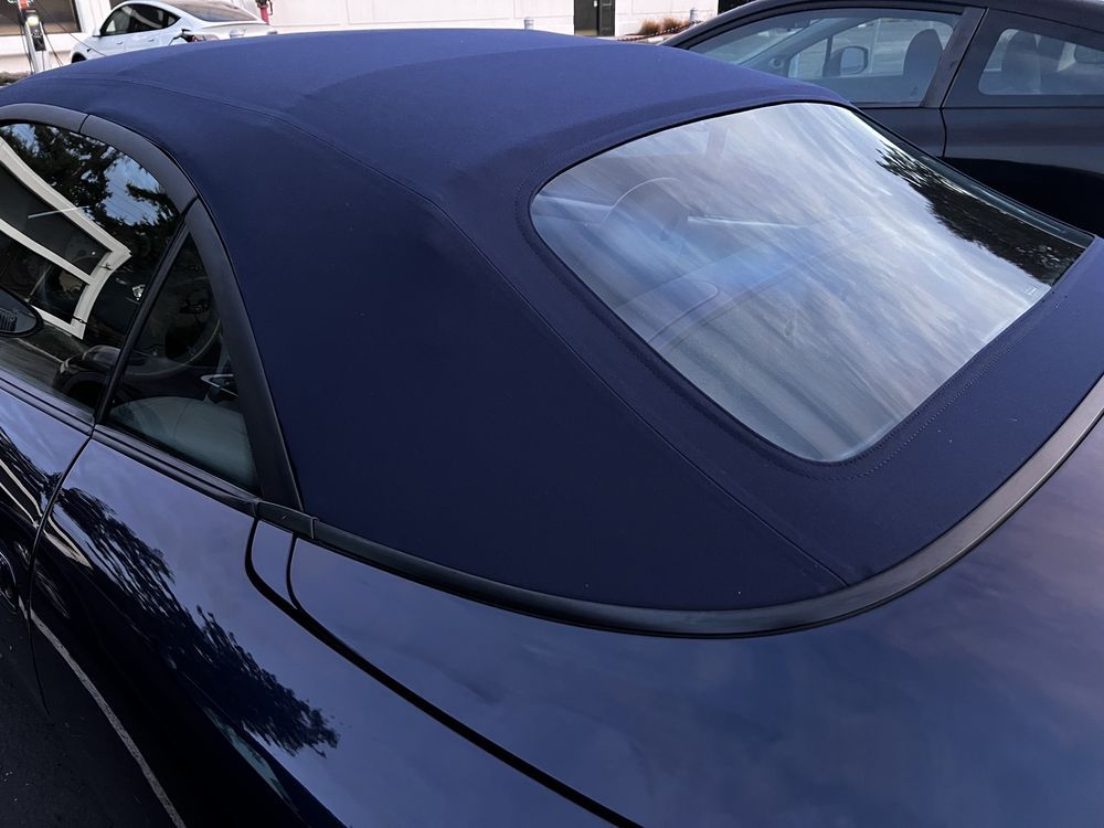 Dark blue convertible car top with rear window.