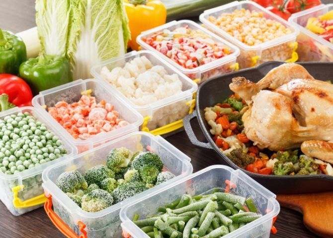 Cajas con diferentes verduras y comida congelada