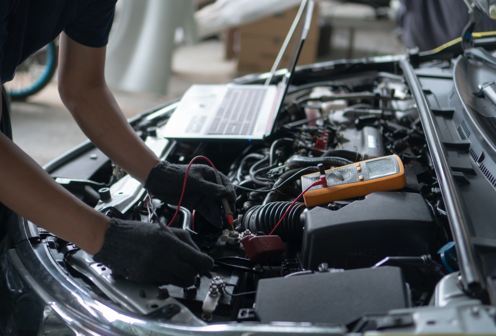 A red semi truck is driving down a wet road at sunset.